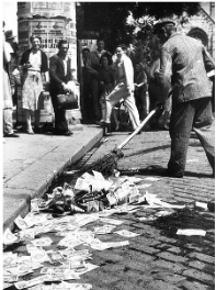 **Image of a German sweeping a street filled with devalued banknotes**