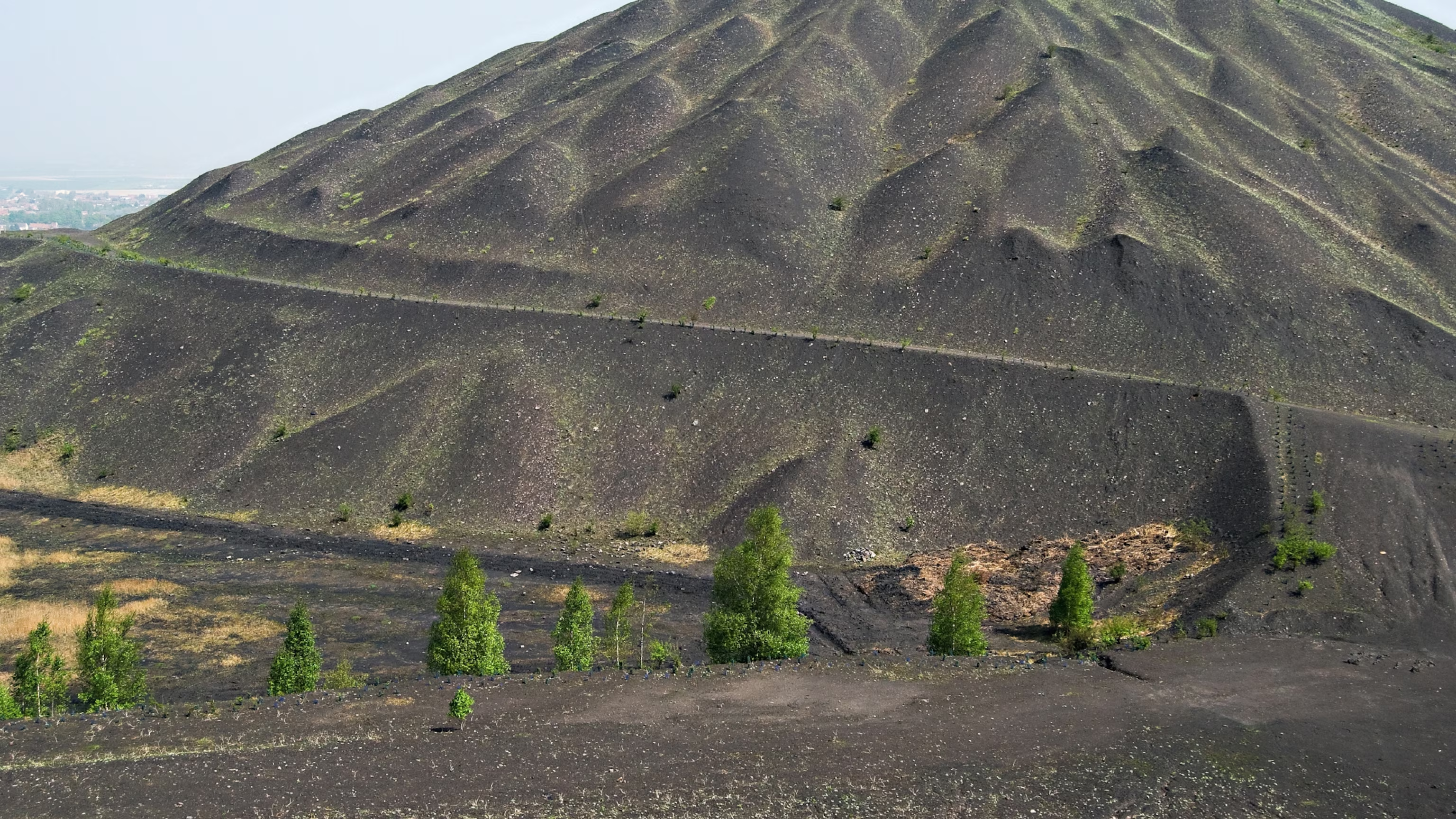 Coal slag heaps are signs of areas suffering from industrial decline