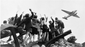 **A United States cargo aeroplane as it flies over the Western section of Berlin**